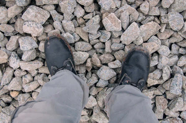 Black work boots on rubble. Shoes for work.