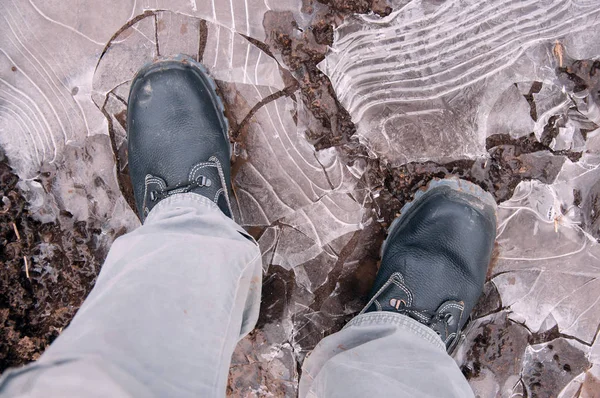 Work boots on a background of frozen ground. Work shoes