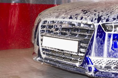 Araba yıkamada köpüklü mavi araba parçası..