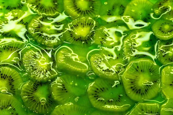 Green jelly with slices of natural fruit - kiwi. Close up. View from above.