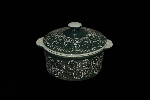 Ceramic pan on a black background.