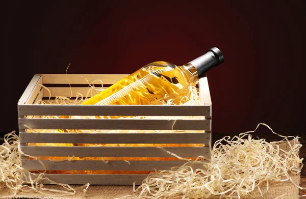 Gift bottle of wine on shot close-up on a red background — Stock Photo, Image