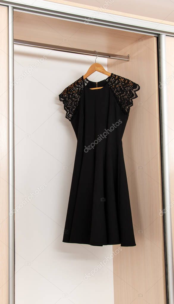 Female dress in a closet on a hanger is shot close-up