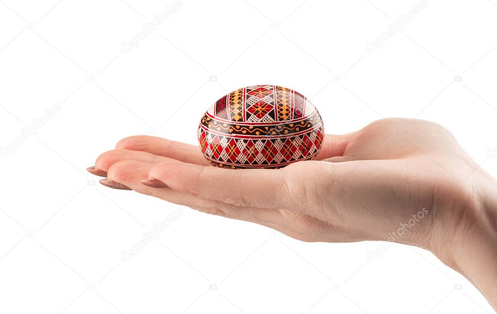 Easter egg in woman hand on a white background