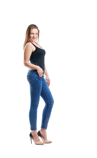 Girl posing in jeans in front of the camera — Stock Photo, Image
