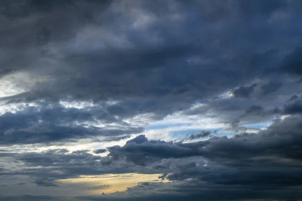 Background of dramatic sky with dark clouds. Sky before a thunder-storm. Abstract natural sky background.