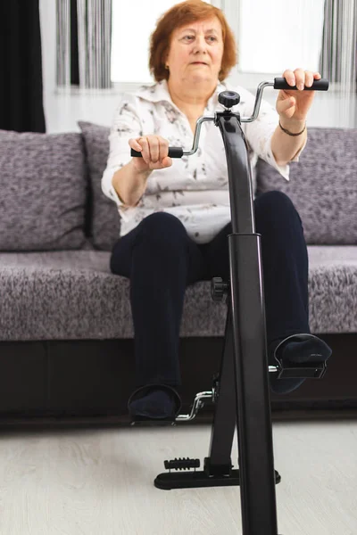 Senior woman training at home. Senior woman make exercise at hom — Stock Image Senior woman training at home. Senior woman make exercise at hom Royalty Free Stock Images