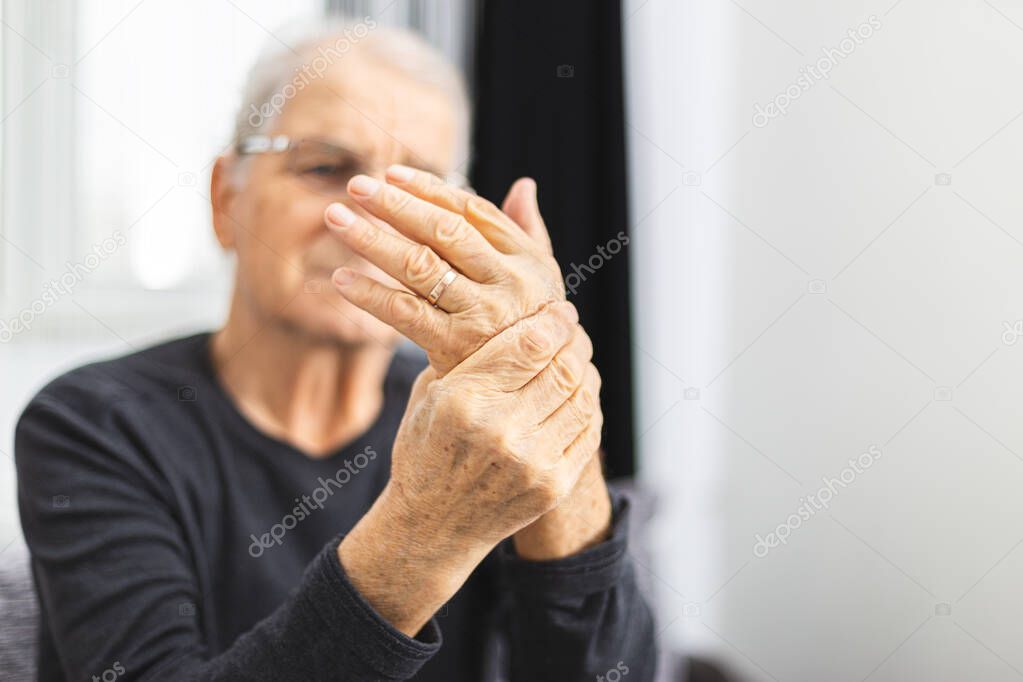 Elderly Person With Painful Hand . Old man have a problem with circulation hands.