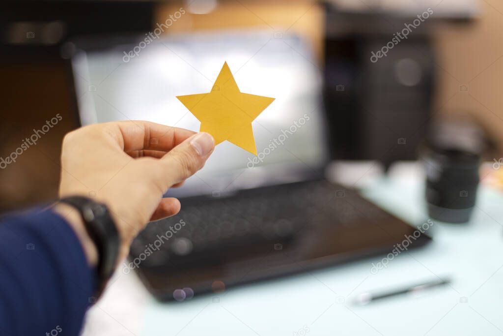 Person holding a five star paper, excellent rating. Feedback, Rated, Customer Experience Concept