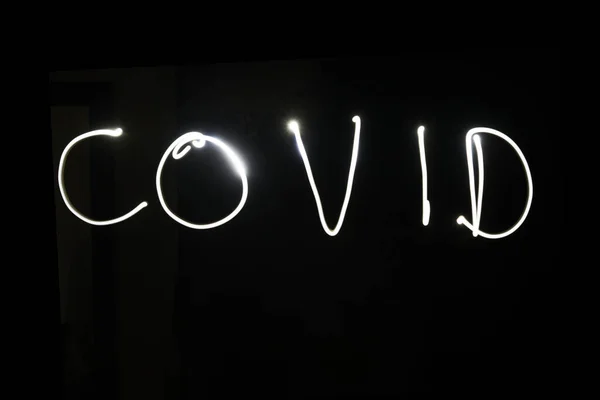 Covid Name Light Painting Photography Tegen Een Zwarte Achtergrond — Stockfoto