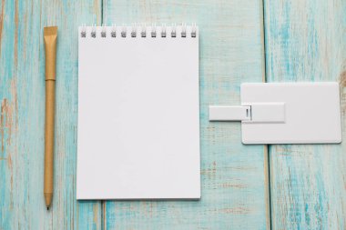 Zarf, usb birden parlamak oyun kağıdı, defter, kalem ile çalışma alanı. Ofis Resepsiyon ahşap arka plan üstten görünüm kadar sahte