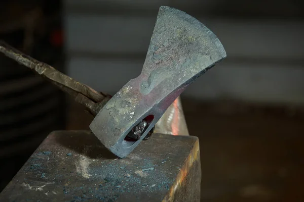 Creating iron tools in blacksmith's on the old plank wood table — Stock Photo, Image