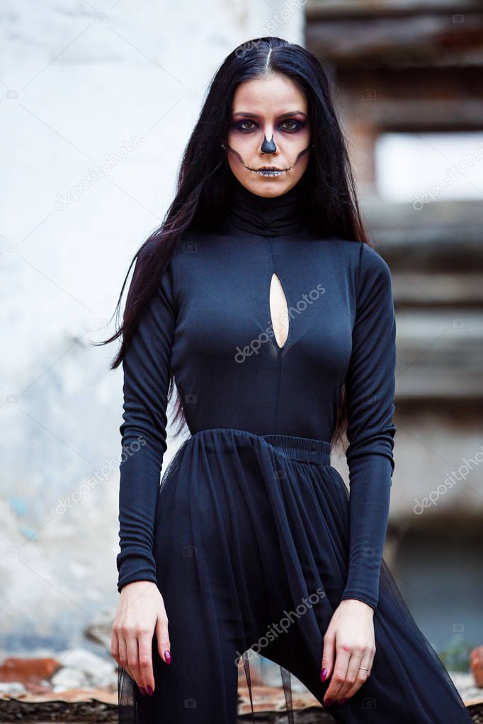 Halloween skeleton witch Woman portrait. Beautiful Glamour Fashion Sexy Vampire Lady with long Dark Hair, Beauty Make Up and Costume