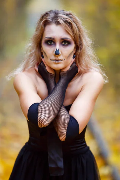 A woman is wearing skeleton makeup on her face  for a Halloween celebration or costume idea.outdoor. Beauty from the Hell, spooky female portrait, — Stock Photo, Image