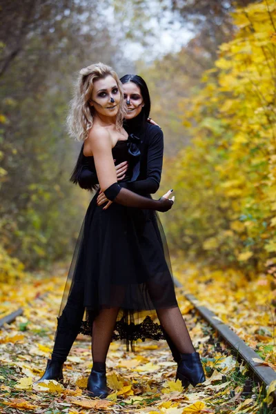 Two vintage witches gathered for the sabbat eve of Halloween.autumn. day, railway rails. — Stock Photo, Image