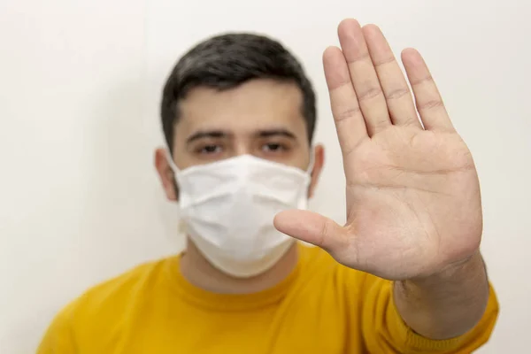 COVID-19 Coronavirus 'u durdurun, beyaz arka planda genç bir adam, yakın plan fotoğrafı