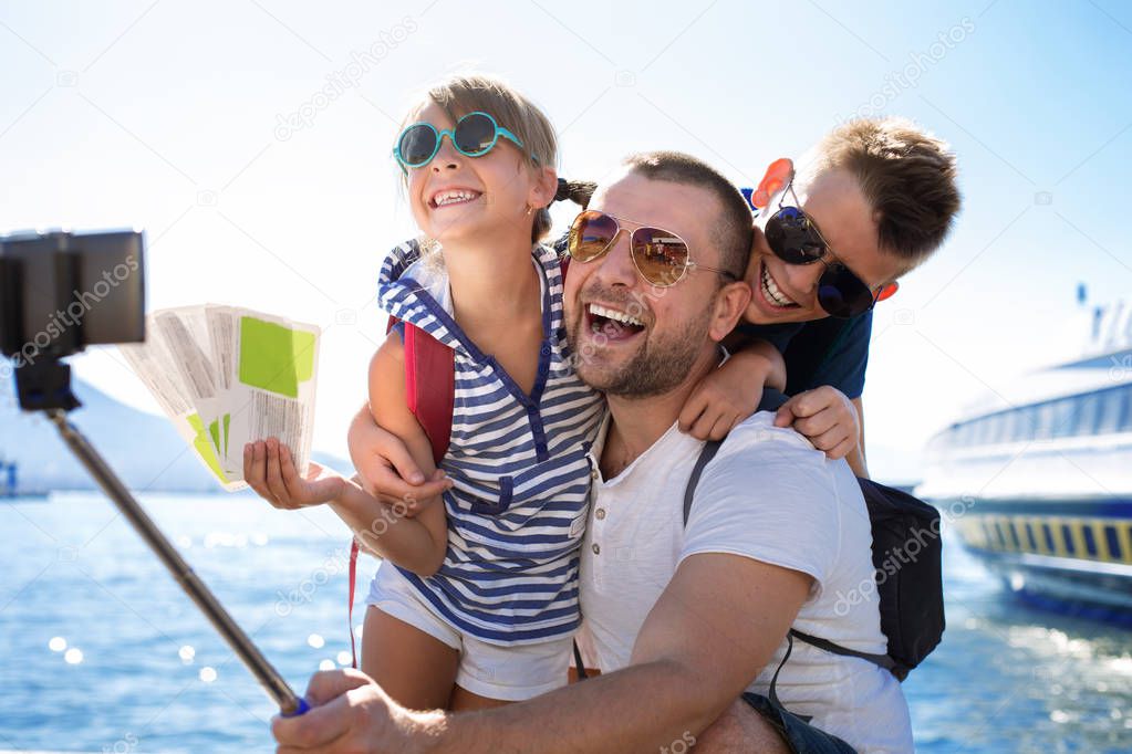 Summer holidays.Father with children are waiting summer sea vacation