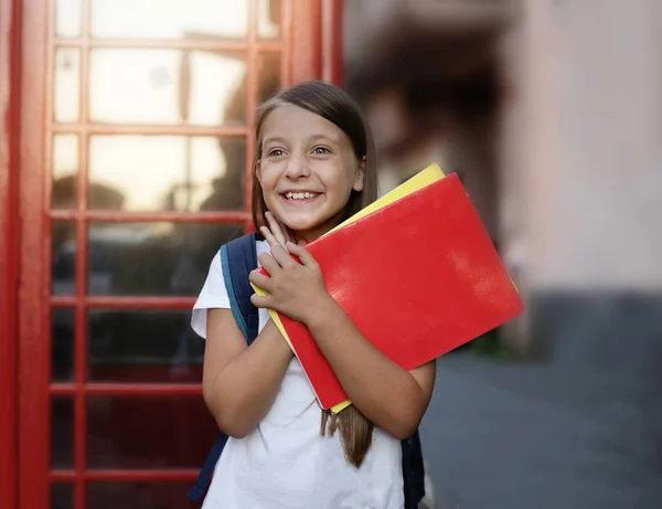 Education, school, knowledge and people concept. Cute teens girl is studying in English school