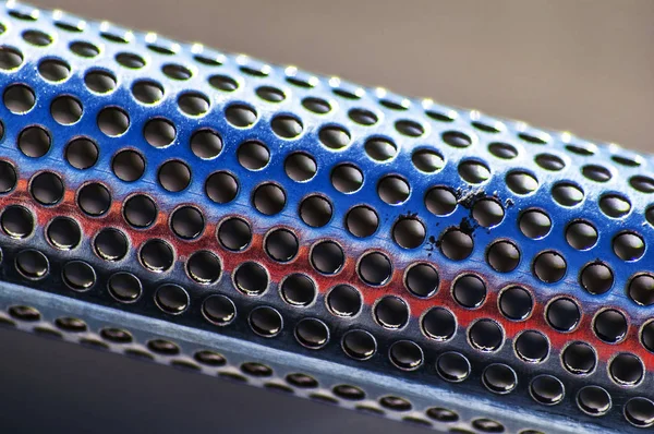 Background of the metal tube with holes