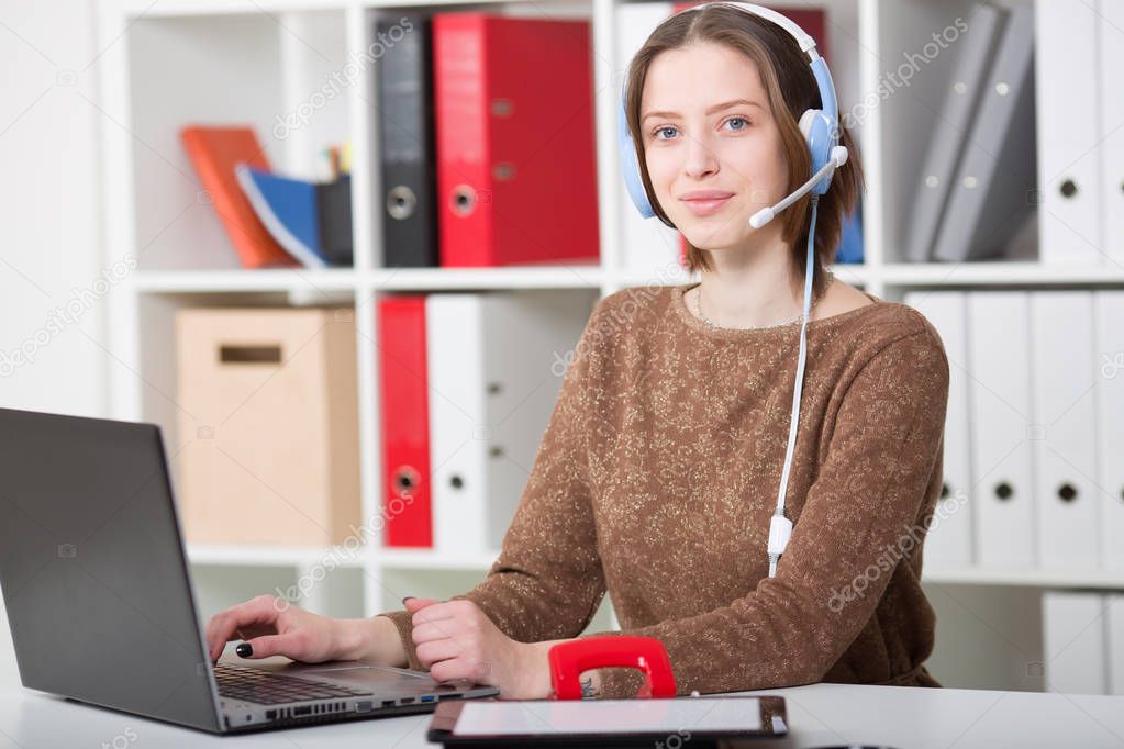 Student woman uses a headset with a microphone for online learning university