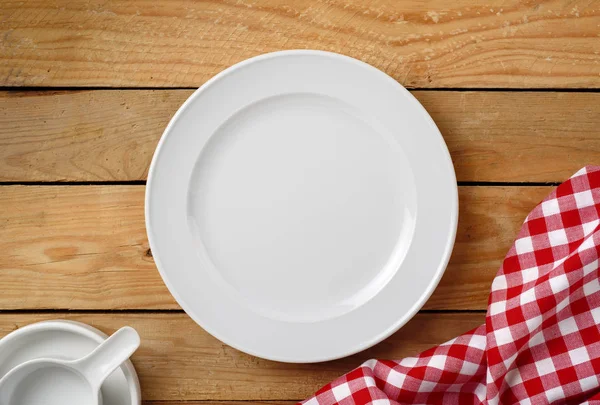 White dish on aged blue table — Stock Photo, Image