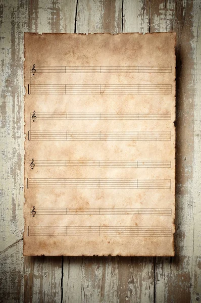 Old music msheet on aged wood — Stock Photo, Image