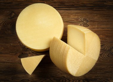 manchego cheese on dark wood clipart