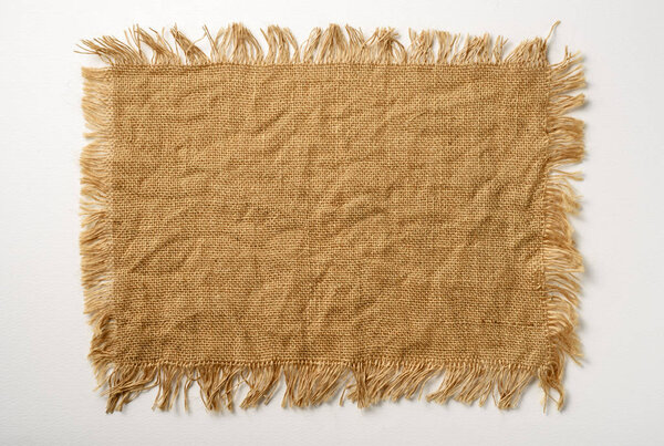 piece of clthsack on white paperboard