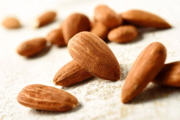 Natural almonds on white table — Stock Photo, Image