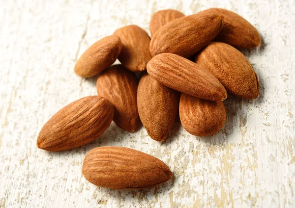 Natural almonds on white table — Stock Photo, Image