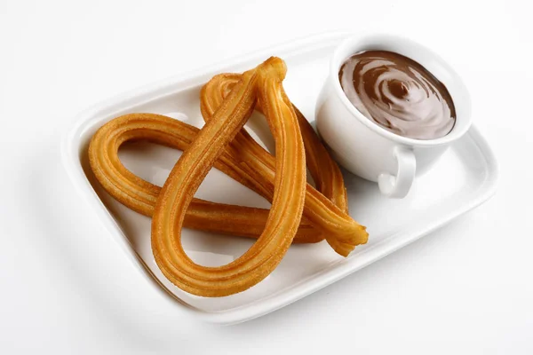 Churros s čokoládou na bílý plech — Stock fotografie