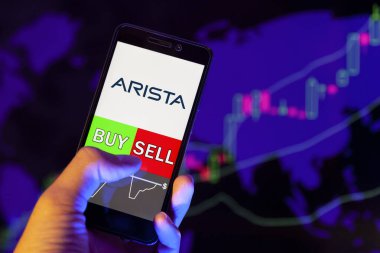 Yessentuki, Rusya - 25 Temmuz 2019: Akıllı telefon ekranında şirket logosu Arista Networks, hisse senedi grafiğinin arka planında Buy ya da Satış 'ı gösteren cep telefonu tüccarının eli