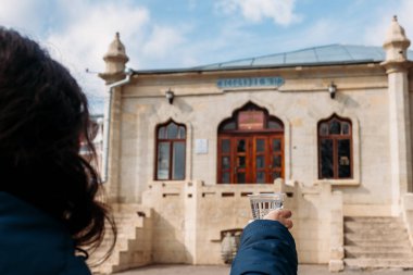 Yessentuki, Stavropol Territory / Russia - February 26, 2019: Drinking gallery of mineral spring Essentuki 17. young woman holding a glass of mineral water