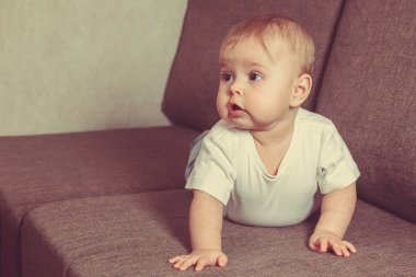 Küçük bebek yatakta emekliyor. Ailede bir çocuğun olması. Duygusallık çocuğum. Boşluğu kopyala.