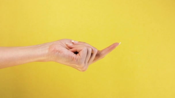 Beckoning sign. Come here. Single handed gesture. closeup. Isolated on yellow background — Stock Video