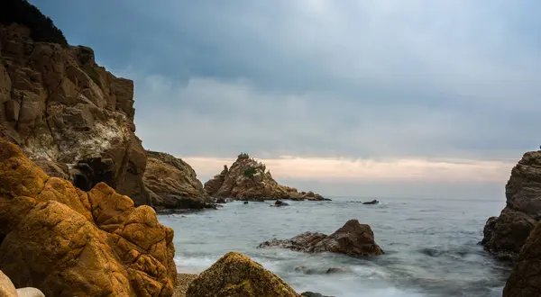 Puesta de sol en una sola playa llena de rocas . —  Fotos de Stock