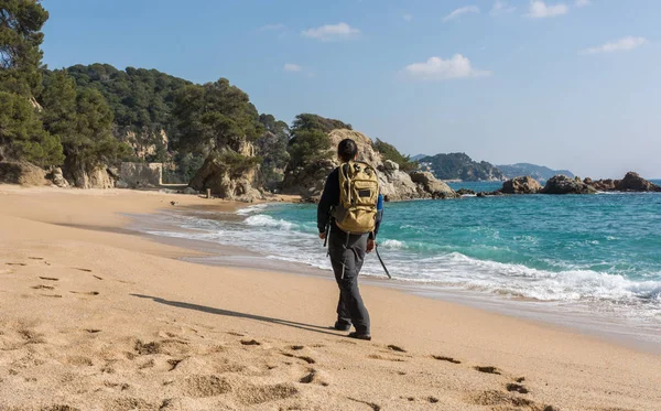Hombre caminando entre las rocas cerca de un paraíso de playa —  Fotos de Stock