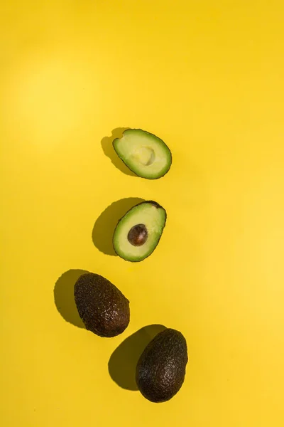 Avocados cut on a background of color — Stock Photo, Image