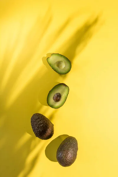 Avocados cut on a background of color — Stock Photo, Image