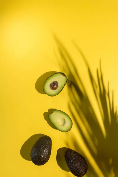 Avocados cut on a background of color — Stock Photo, Image