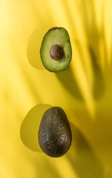 Avocados cut on a background of color — Stock Photo, Image