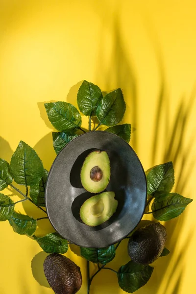 Avocados cut on a background of color — Stock Photo, Image