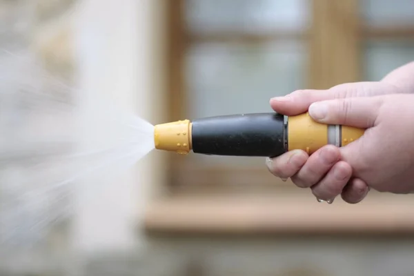 Kadının eli hortumla sulanıyor..