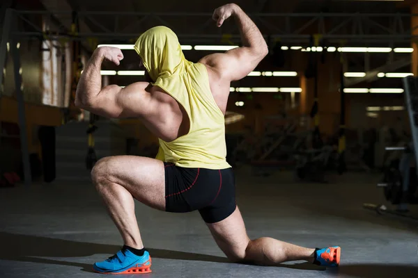 Portrait d'un homme de fitness faisant des exercices d'étirement à la salle de gym — Photo