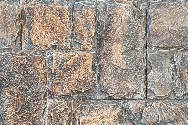 Lavori in pietra asimmetrici. Close-up luminoso mattoni vintage sfondo della parete. muro di pietra per sfondo texture . — Foto Stock
