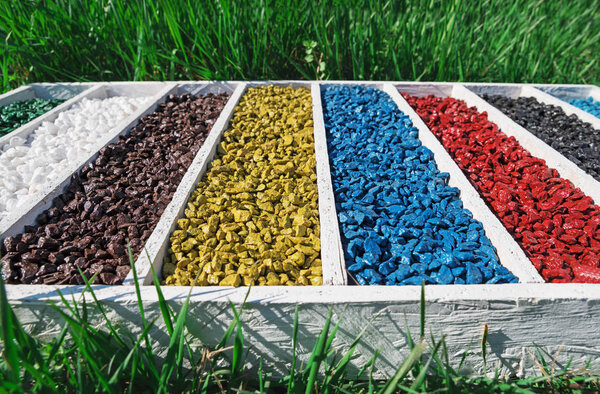 colorful rocks in wooden box On the green grass, art Aquarium Fish Tank Gravel Stones Color