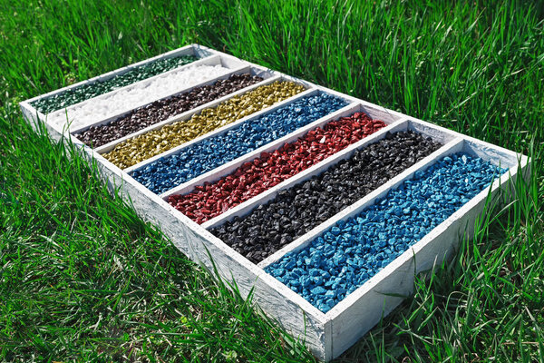 colorful rocks in wooden box On the green grass, art Aquarium Fish Tank Gravel Stones Color