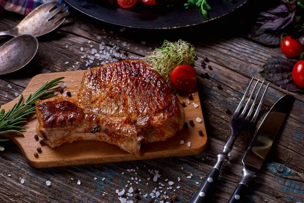 Grilled meat and vegetables on rustic wooden table