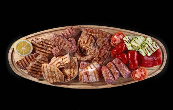 Big wooden board with assorted meats, preferably served as companion for beer or other alcohol drinks — Stock Photo, Image