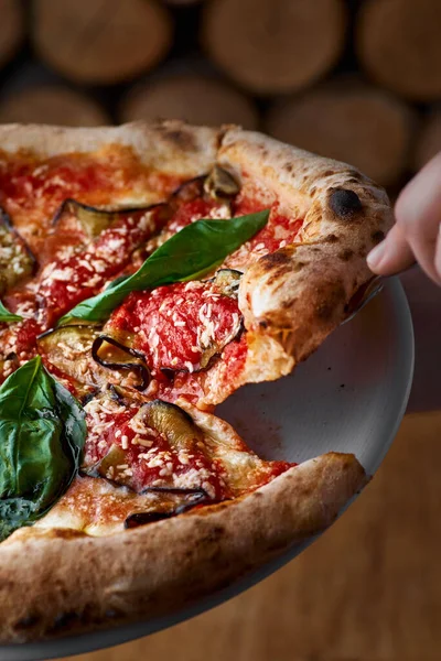 Traditionele Italiaanse pizza met aubergines, mozzarella, basilicum en tomaten op houten ondergrond — Stockfoto
